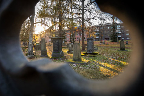 Hautamuistomerkin kolosta näkyy kuusi kivistä muistomerkkiä ja puita.