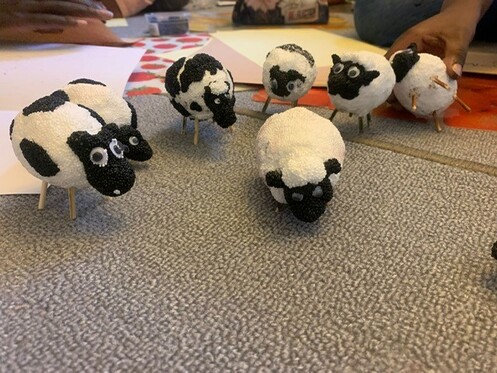 Toy sheep set on the floor during Sunday school.