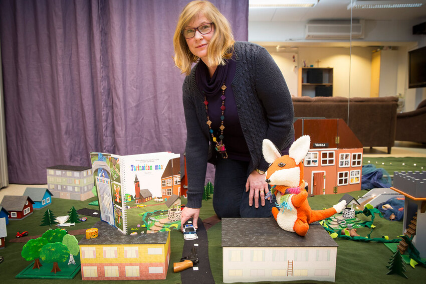 Puiset lelutalot, pikkuautot, Duplo-eläimet ja ihmiset muodostavat kaupungin tarinamaton päälle.