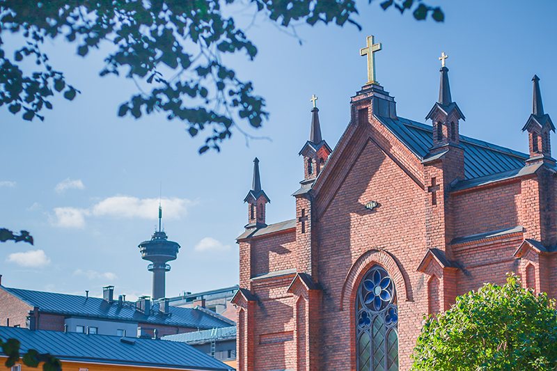Finlayson Church on a sunny summer day, with Näsinneula tower visible in the background.